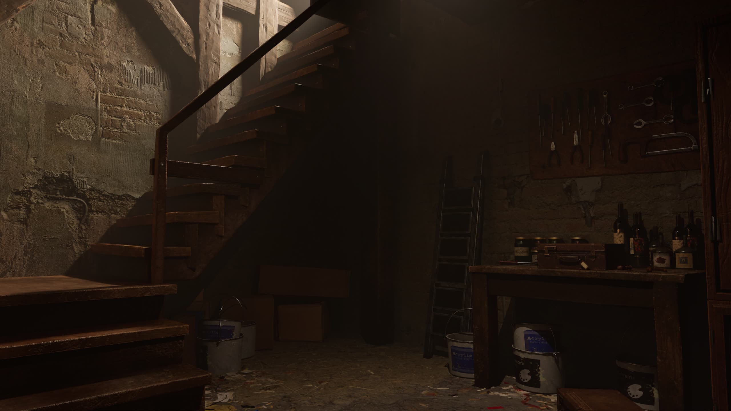 Basement with wooden stairs, a tool wall, and a workbench lit by a single shaft of light